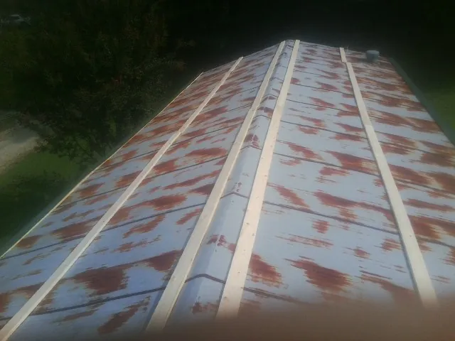 Rusted metal roof panels with new wood purlins before replacement — Storm Damage Roof Repair in South Houston by Roofing Brothers