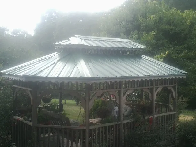 Two tier green metal roof on a garden gazebo in South Houston